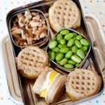breakfast bento with waffle sandwiches, walnuts and edamame beans