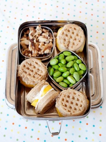 breakfast bento with waffle sandwiches, walnuts and edamame beans