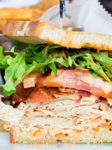 sandwich with chicken, bacon, and veggies