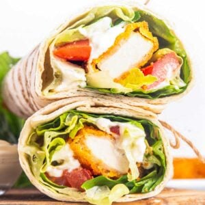 two halves of a chicken nugget wrap filled with veggies and ranch dressing