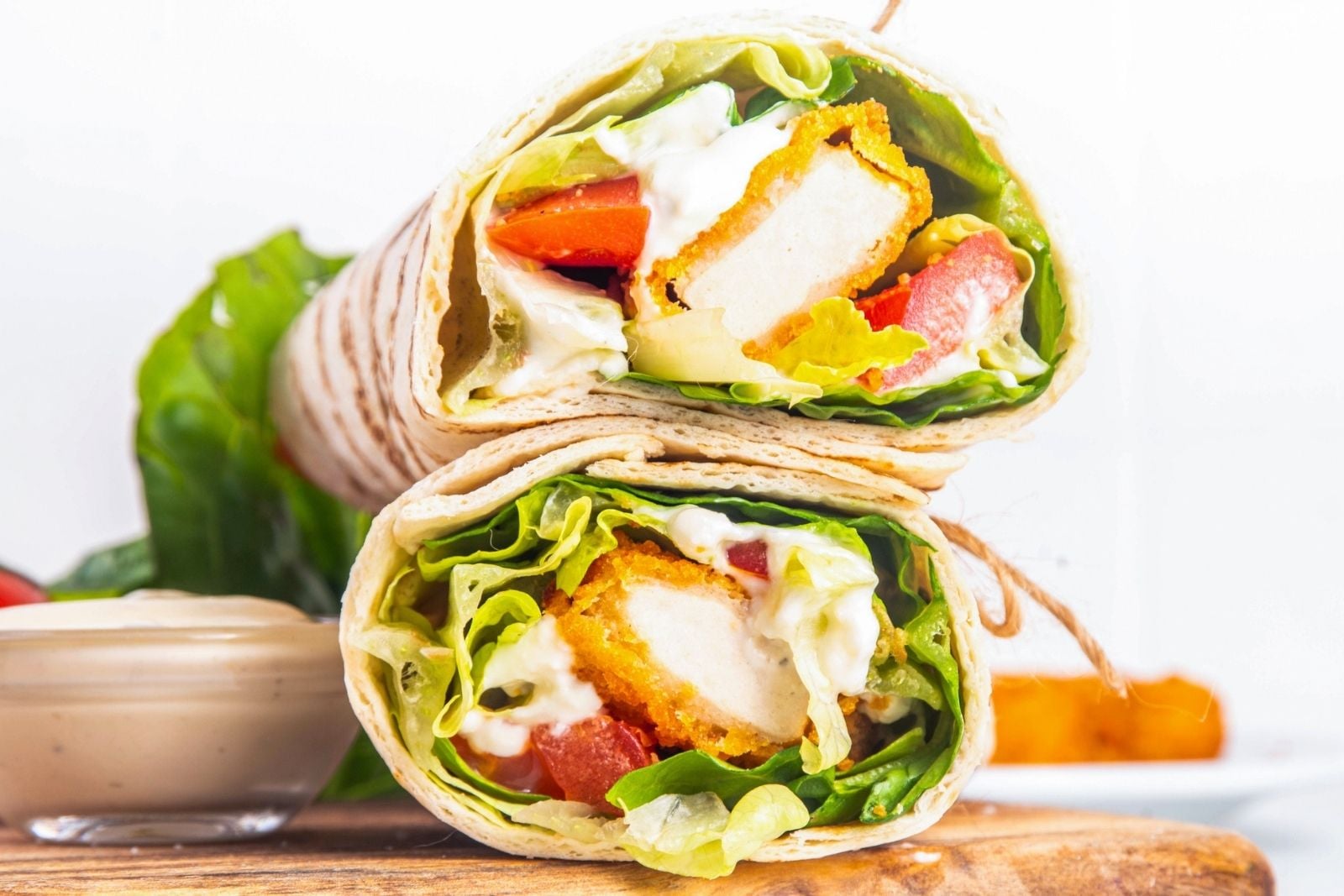 two chicken nugget wraps on a cutting board