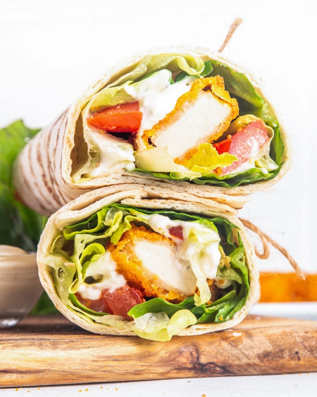 two chicken nugget wraps on a cutting board