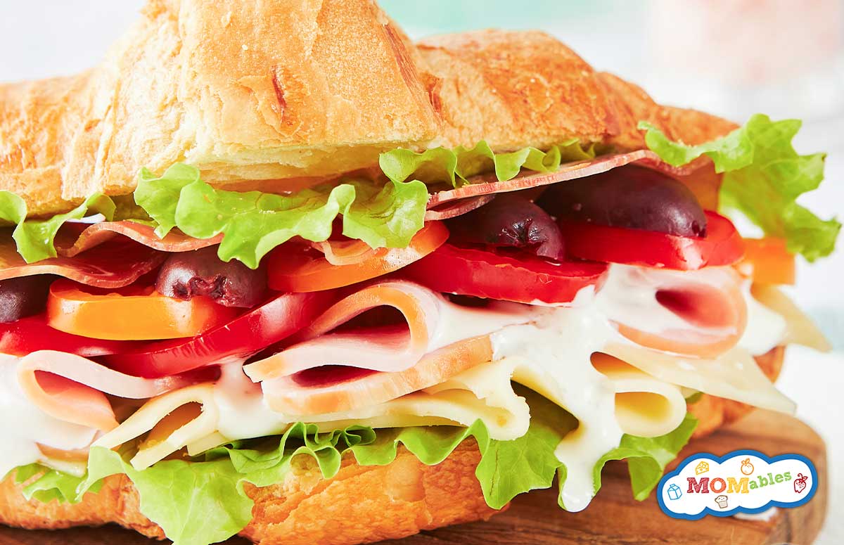 closeup of a ham croissant with veggies