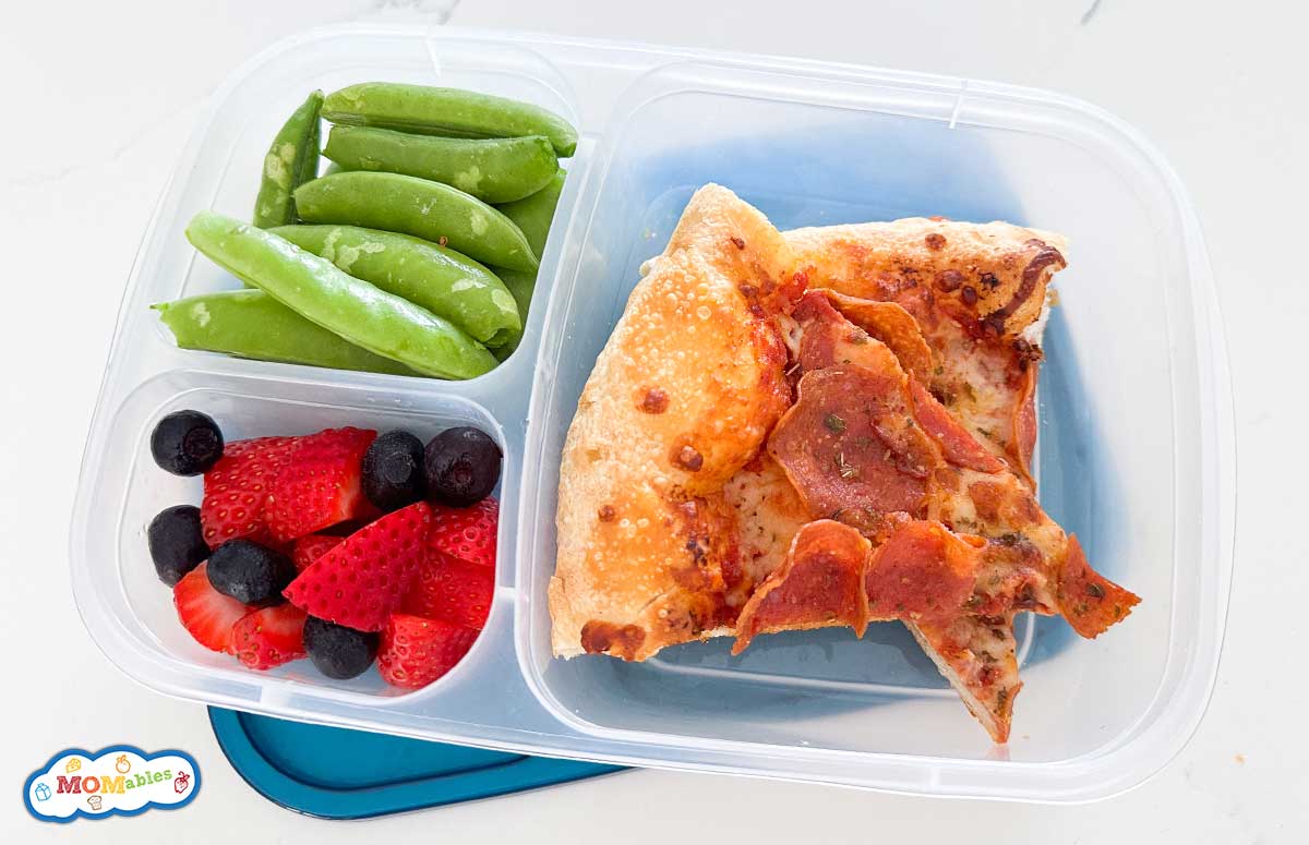 two slices of pepperoni pizza in a lunch container with veggies and berries