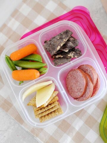 salami and crackers, veggies and a treat in a snack box