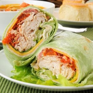 a turkey bacon wrap cut in half on a plate