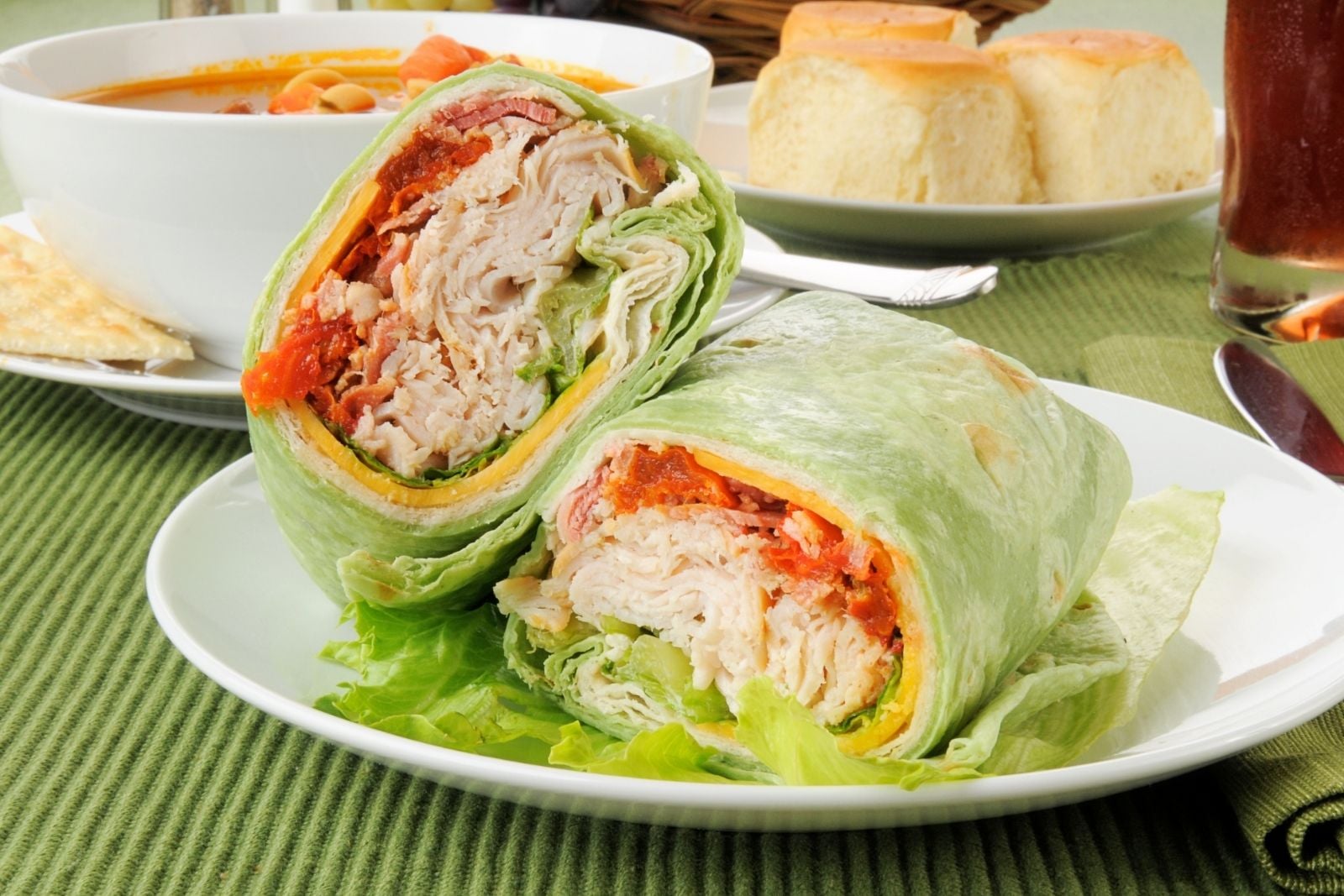 a turkey bacon wrap cut in half on a plate