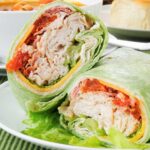 two halves of a turkey bacon wrap on a plate