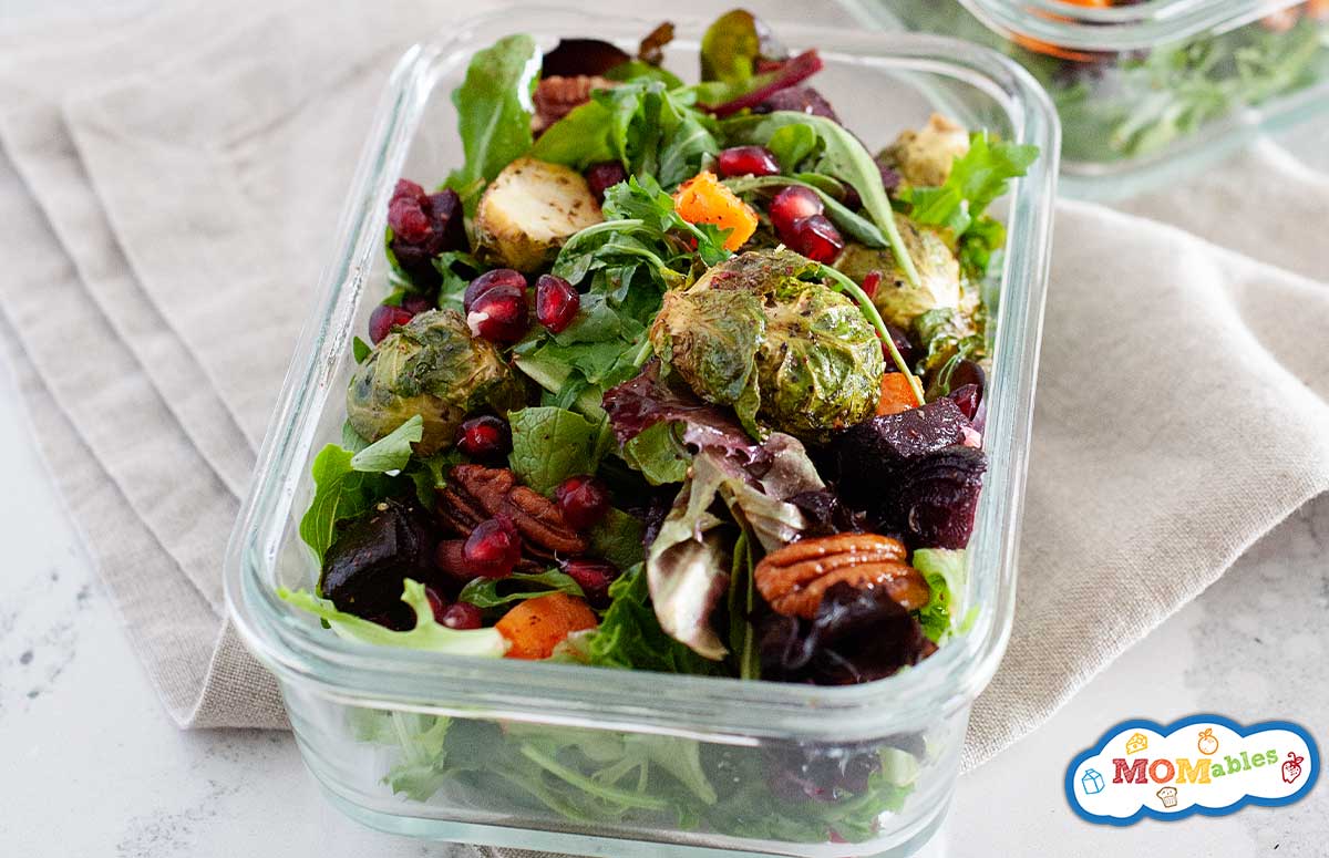 a winter salad in a glass lunch container