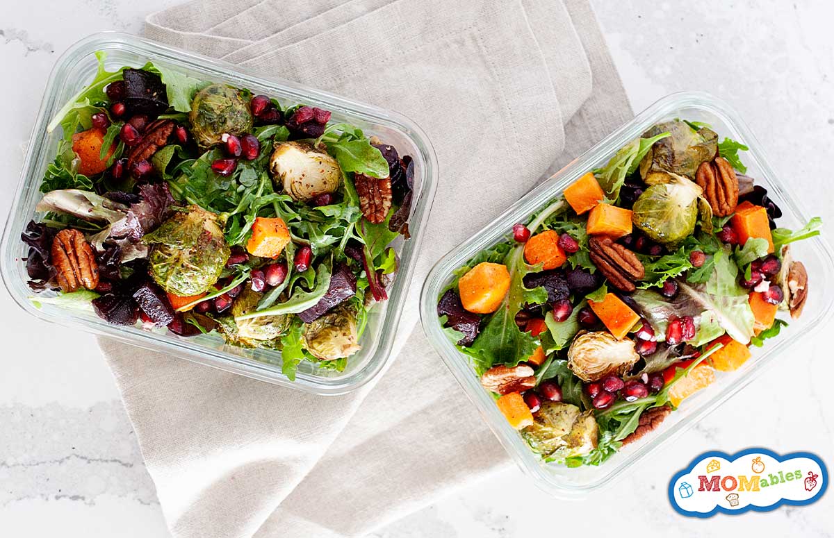 two winter salads with roasted vegetables in glass lunch containers