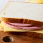 a bologna and swiss sandwich on white bread