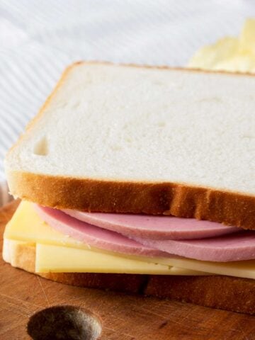 a bologna and swiss sandwich on white bread