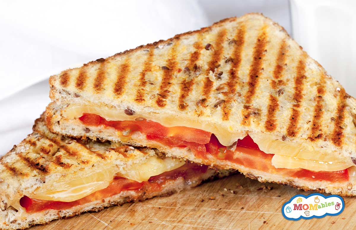 ham tomato an cheese panini cut in half 