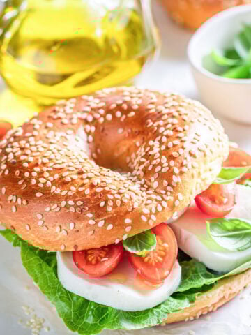 Caprese bagel sandwich with tomatoes, mozzarella and basil
