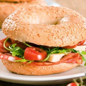Italian bagel sandwich with salami and vegetables
