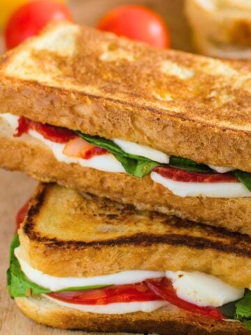 two caprese grilled cheese sandwiches stacked