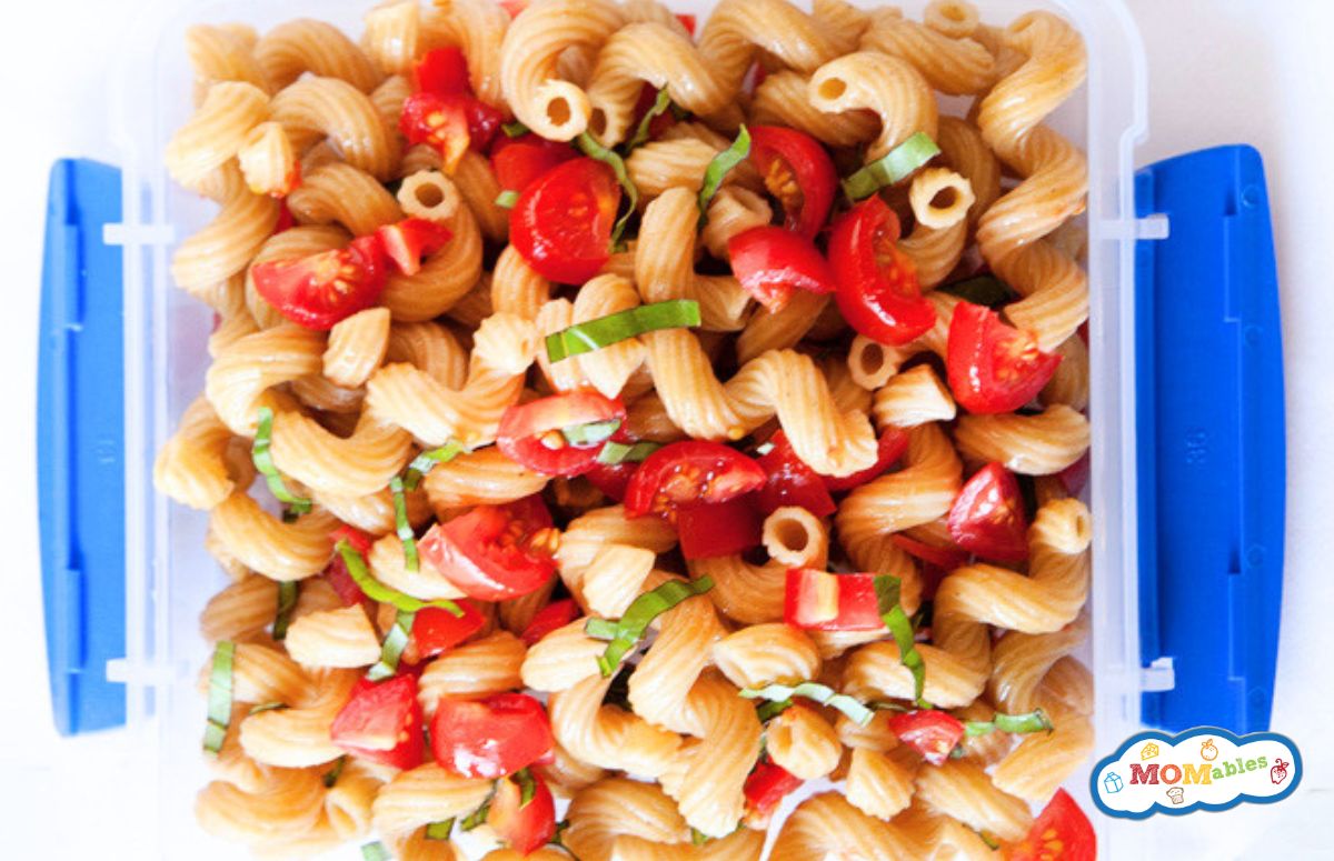 closeup of tomato pasta salad in a school lunch container
