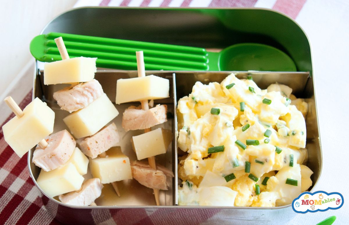 egg salad with skewers of ham and cheese in a lunch container
