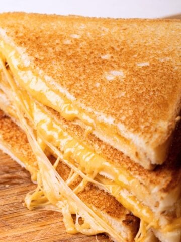 three whole wheat grilled cheese halves stacked