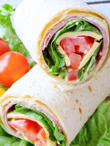 two halves of an Italian sandwich wrap on a countertop
