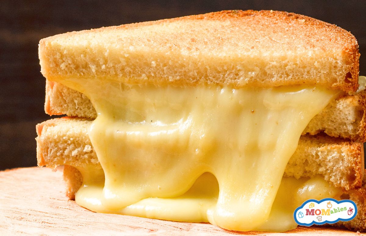 two triangle halves of a melty provolone grilled cheese sandwich, stacked