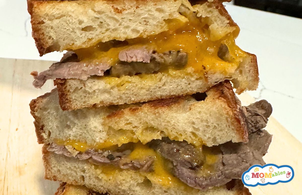 two roast beef grilled sandwiches stacked on each other