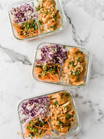 three lunch containers filled with Thai chicken and rice