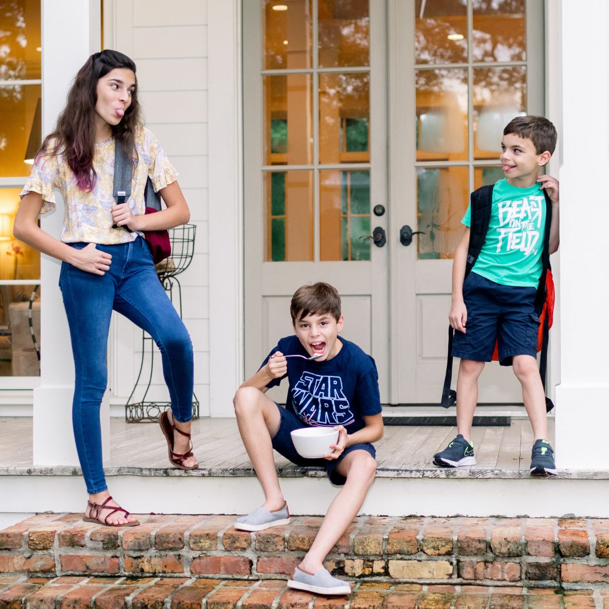 Laura Fuentes kids standing on front porch before school