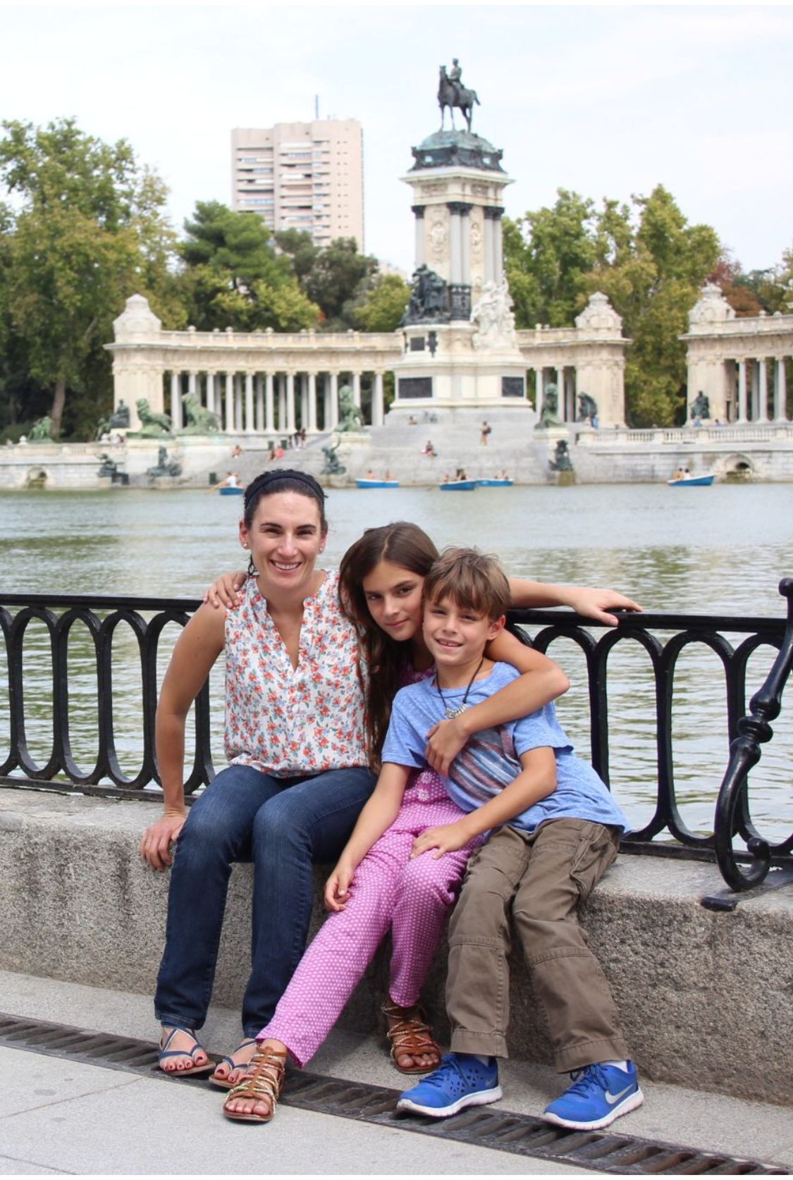 Laura fuentes and two of her children on a bench in Spain