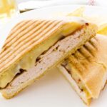 two halves of a turkey and cheese panini
