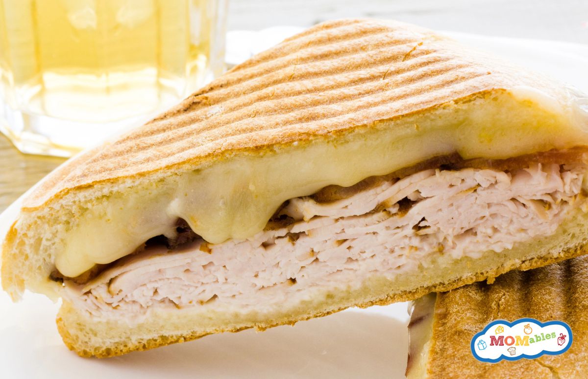 closeup of half a turkey and cheese panini sandwich