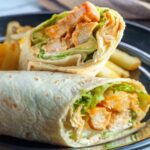buffalo chicken wrap cut in half on a plate