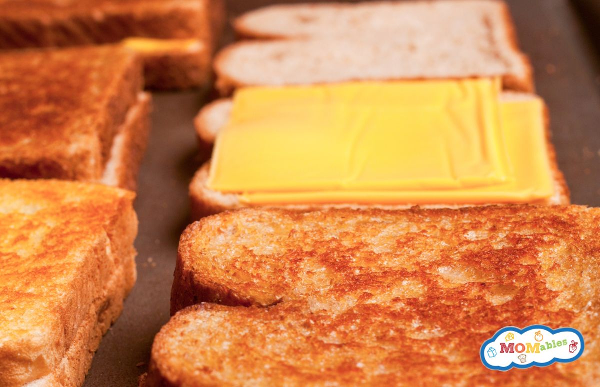 grilled cheese sandwiches on a sheet pan for baking