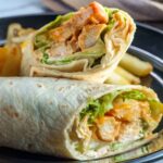 buffalo chicken wrap cut in half on a plate