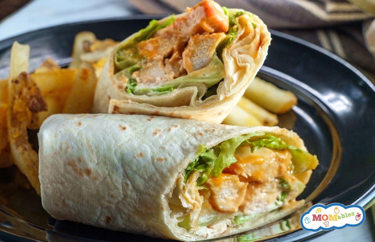 buffalo chicken wrap cut in half on a plate