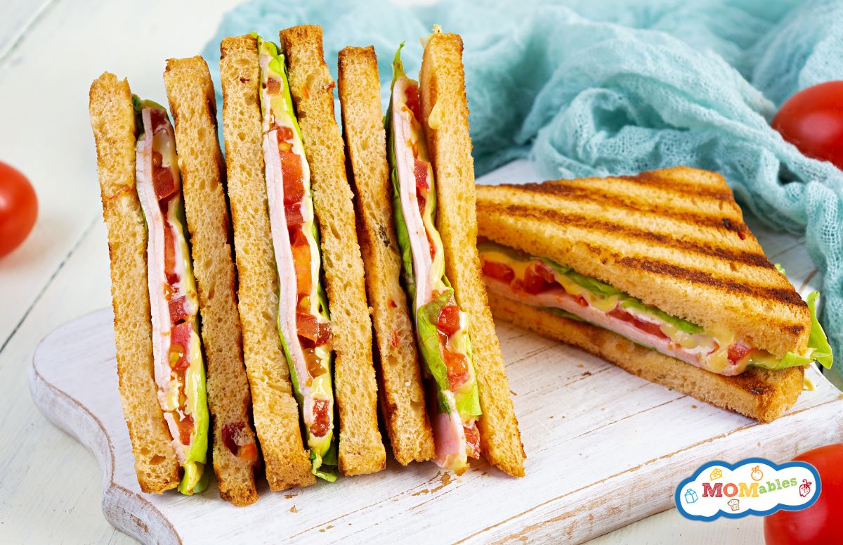 four club sandwiches on a cutting board