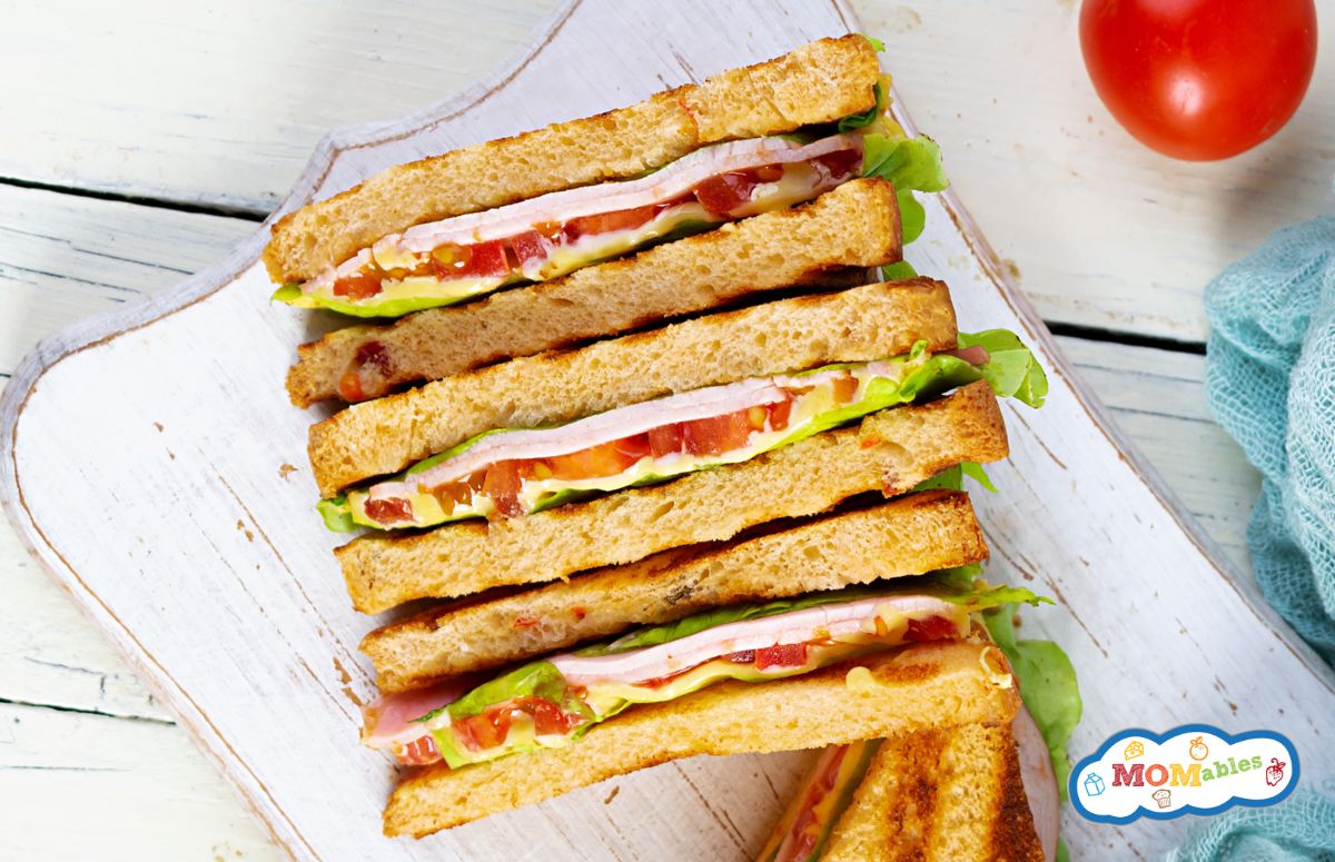 four club sandwiches on a cutting board