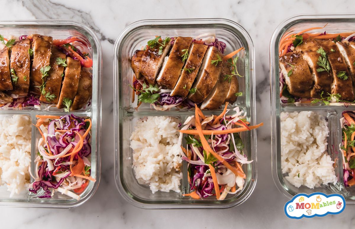 top view of three lunchboxes with korean chicken, rice, and veggies