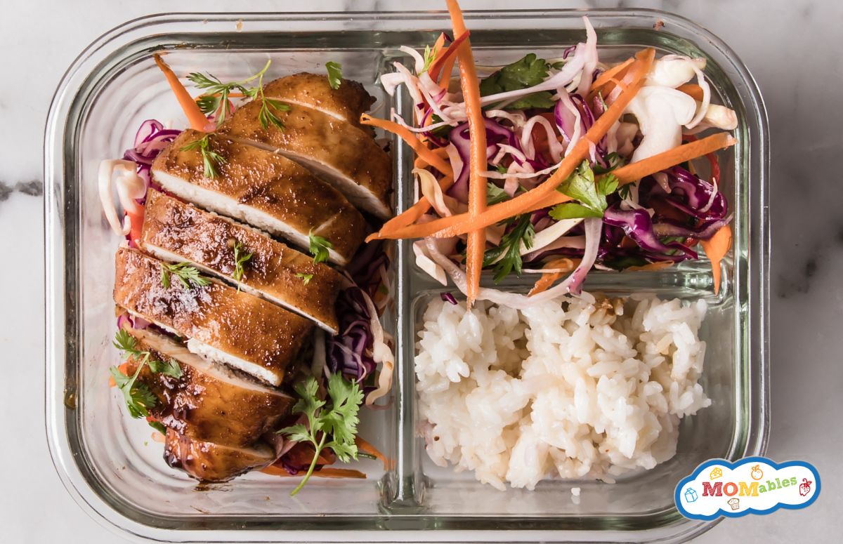 top view of a lunch bowl with korean chicken, rice, and veggies